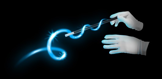 Image of Magician with magic wand performing trick on black background, closeup. Banner design