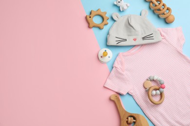 Photo of Flat lay composition with baby clothes and accessories on color background, space for text