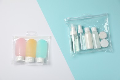 Cosmetic travel kits in plastic bags on color background, top view. Bath accessories