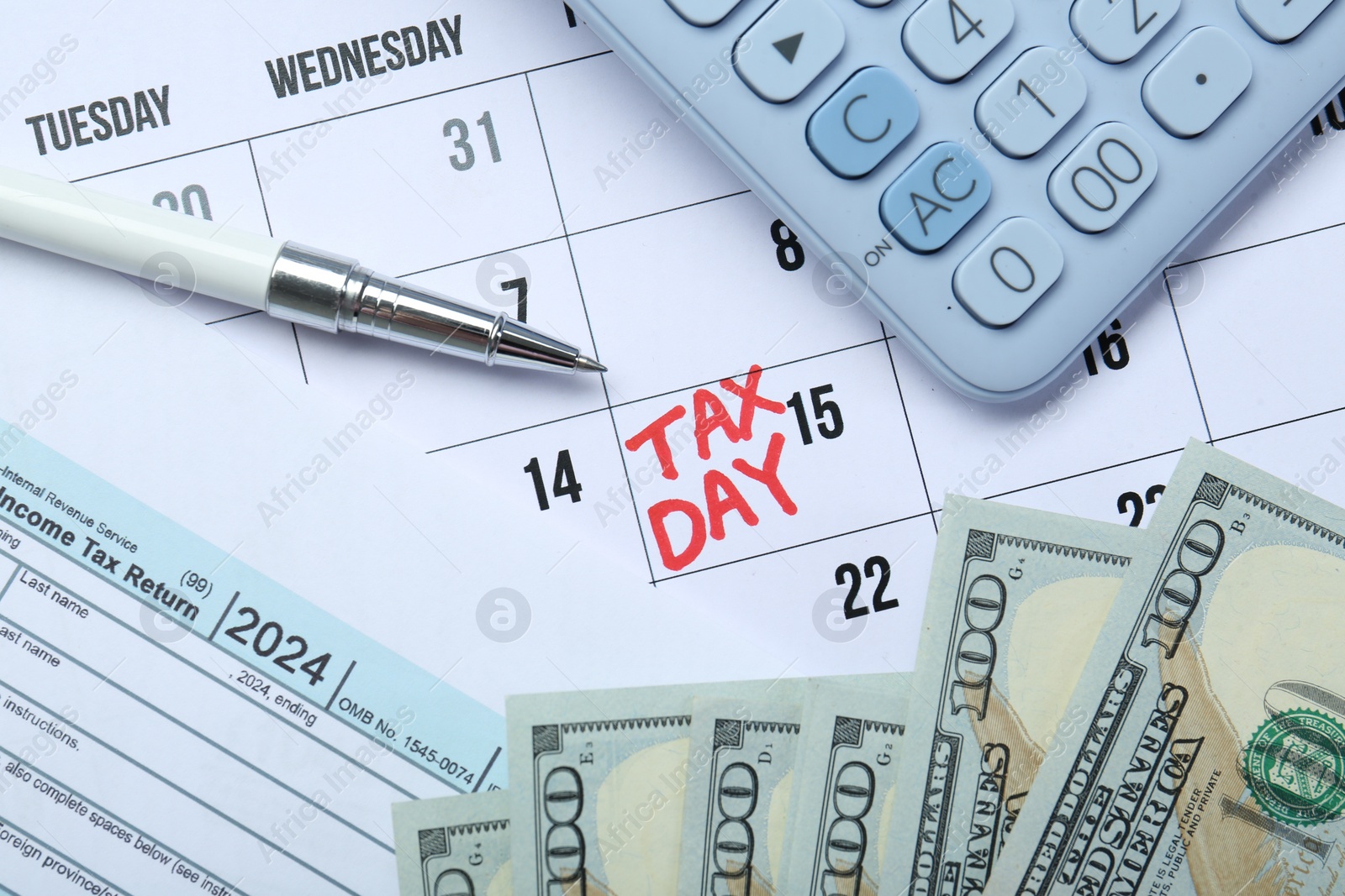 Photo of Calendar with date reminder about tax day, documents, money, pen and calculator, top view