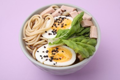 Photo of Bowl of delicious ramen with meat and egg on violet table, closeup. Noodle soup