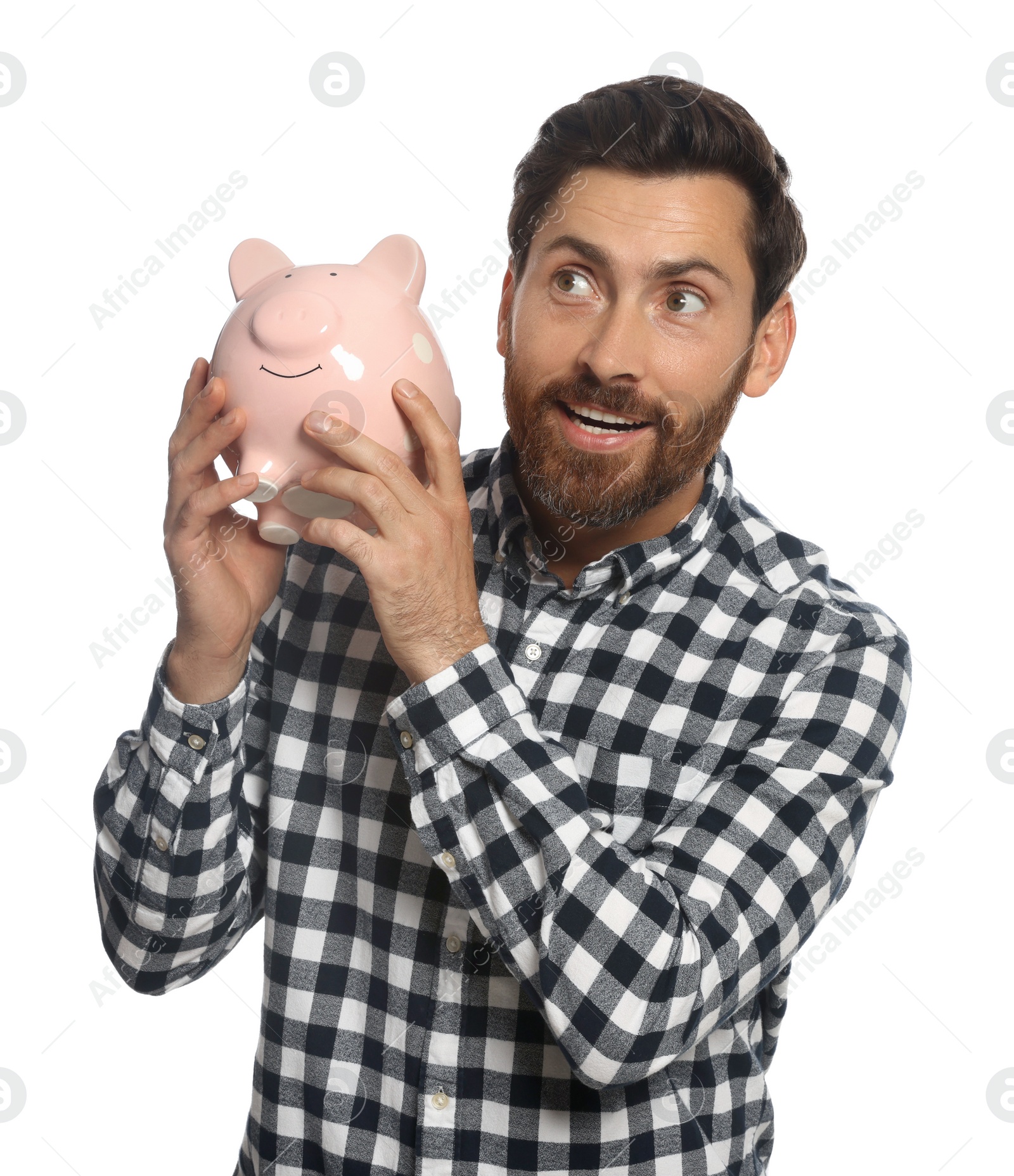 Photo of Happy man with ceramic piggy bank on white background