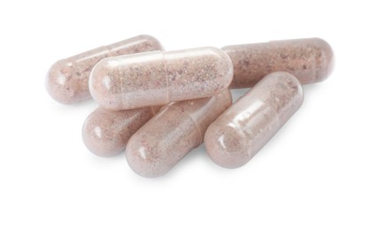 Photo of Many transparent gelatin capsules on white background