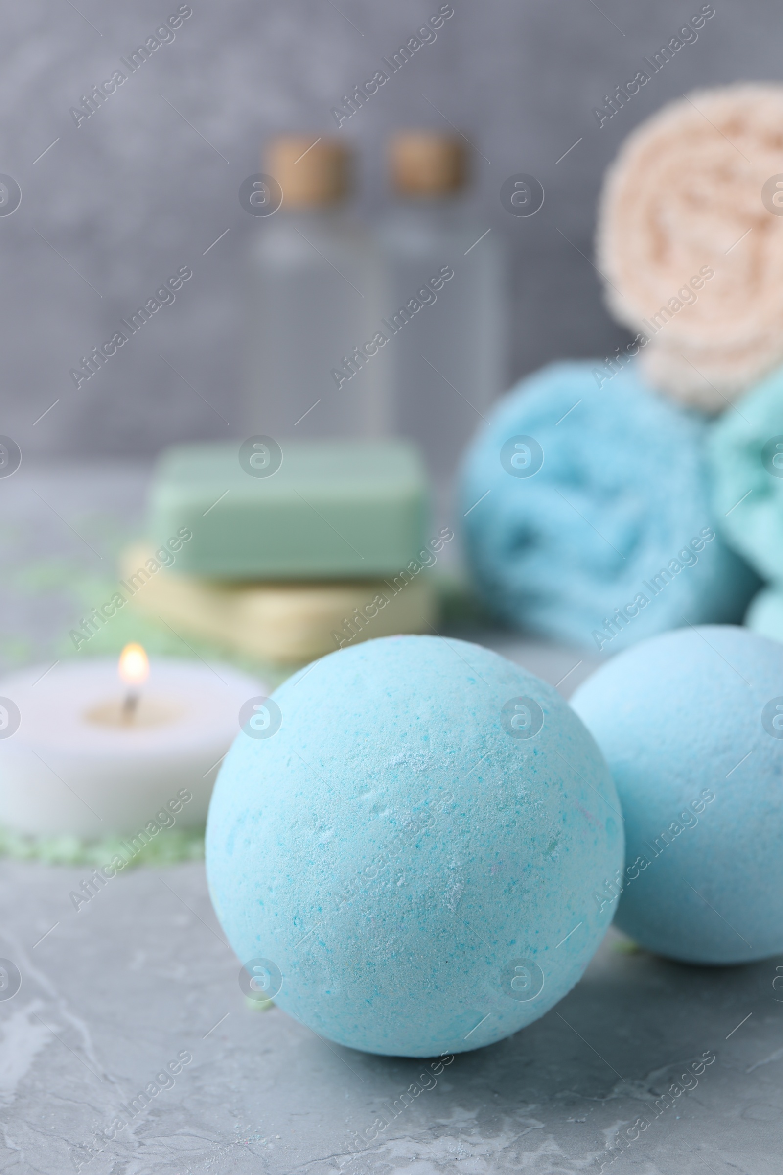 Photo of Beautiful aromatic bath bombs on light grey table, closeup. Space for text