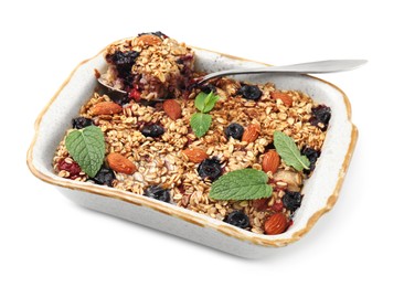 Photo of Tasty baked oatmeal with berries and almonds in baking tray isolated on white