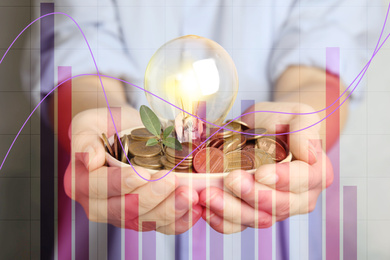 Image of Woman with coins, light bulb and green plant, closeup. Energy saving