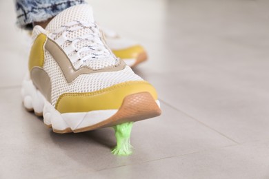 Person stepping into chewing gum on floor, closeup. Space for text