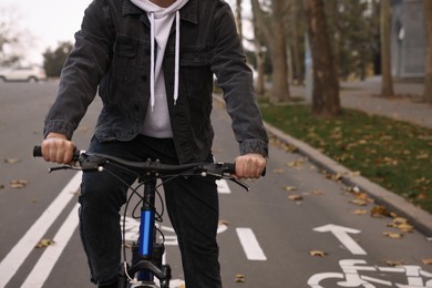 Photo of Man with bicycle on lane in city, closeup