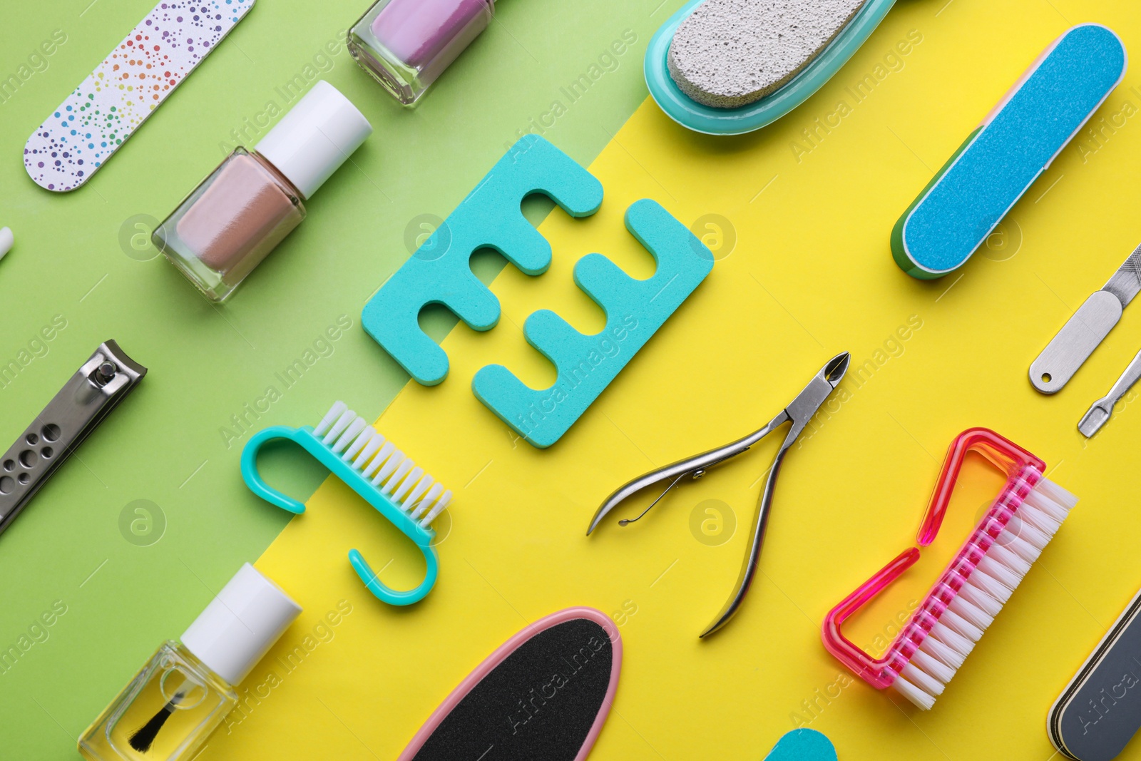 Photo of Set of pedicure tools on color background, flat lay