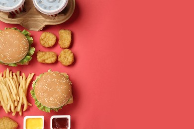 Photo of Flat lay composition with delicious fast food menu on red background. Space for text