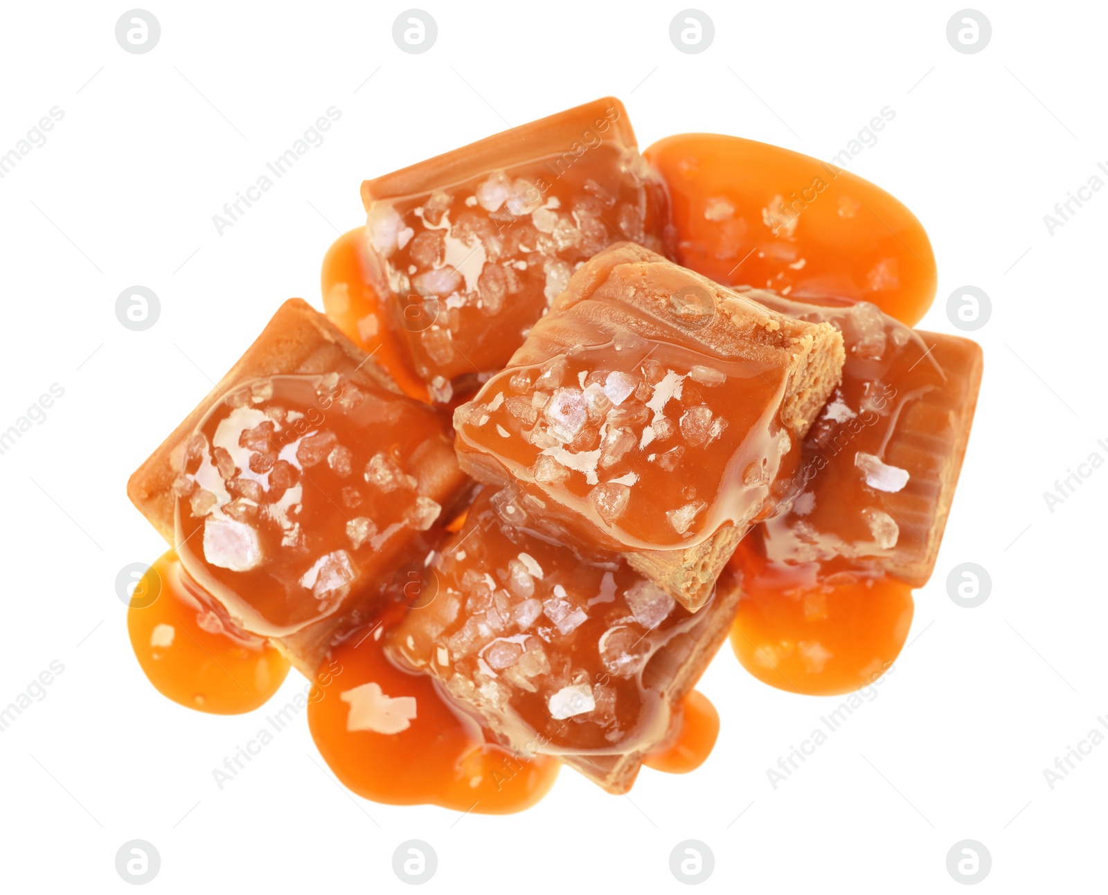 Photo of Delicious salted caramel with sauce on white background, top view