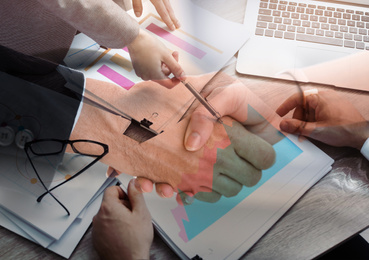 Double exposure of workers with documents and business partners shaking hands, closeup