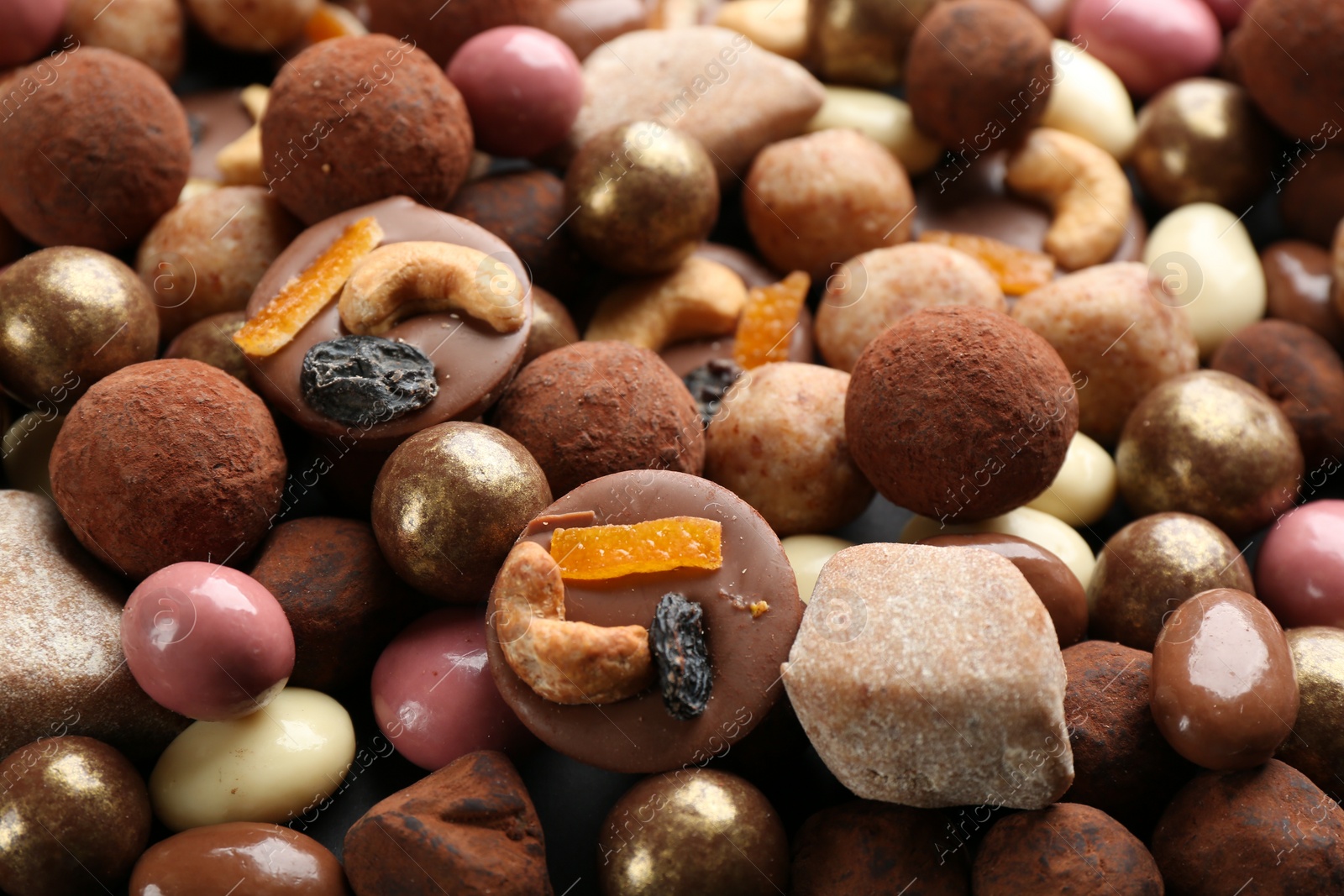 Photo of Different delicious chocolate candies as background, closeup