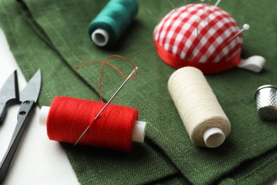 Threads and other sewing supplies on table