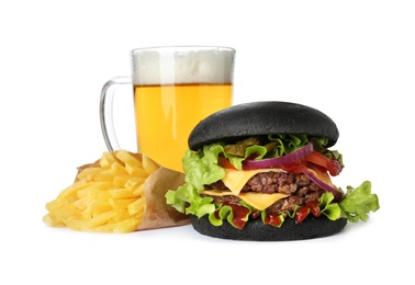 Black burger, French fries and glass of beer isolated on white