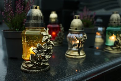 Photo of Grave lights on granite surface at cemetery