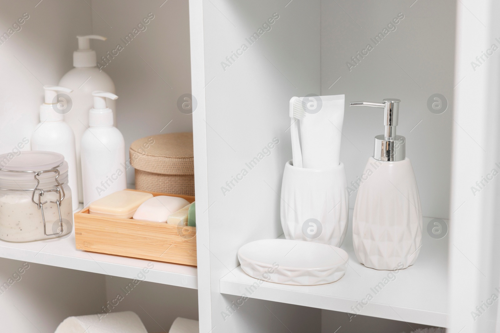 Photo of Different personal care products and bath accessories in bathroom vanity