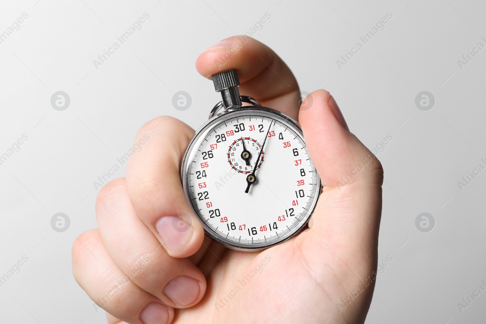 Photo of Man holding vintage timer on white background, closeup