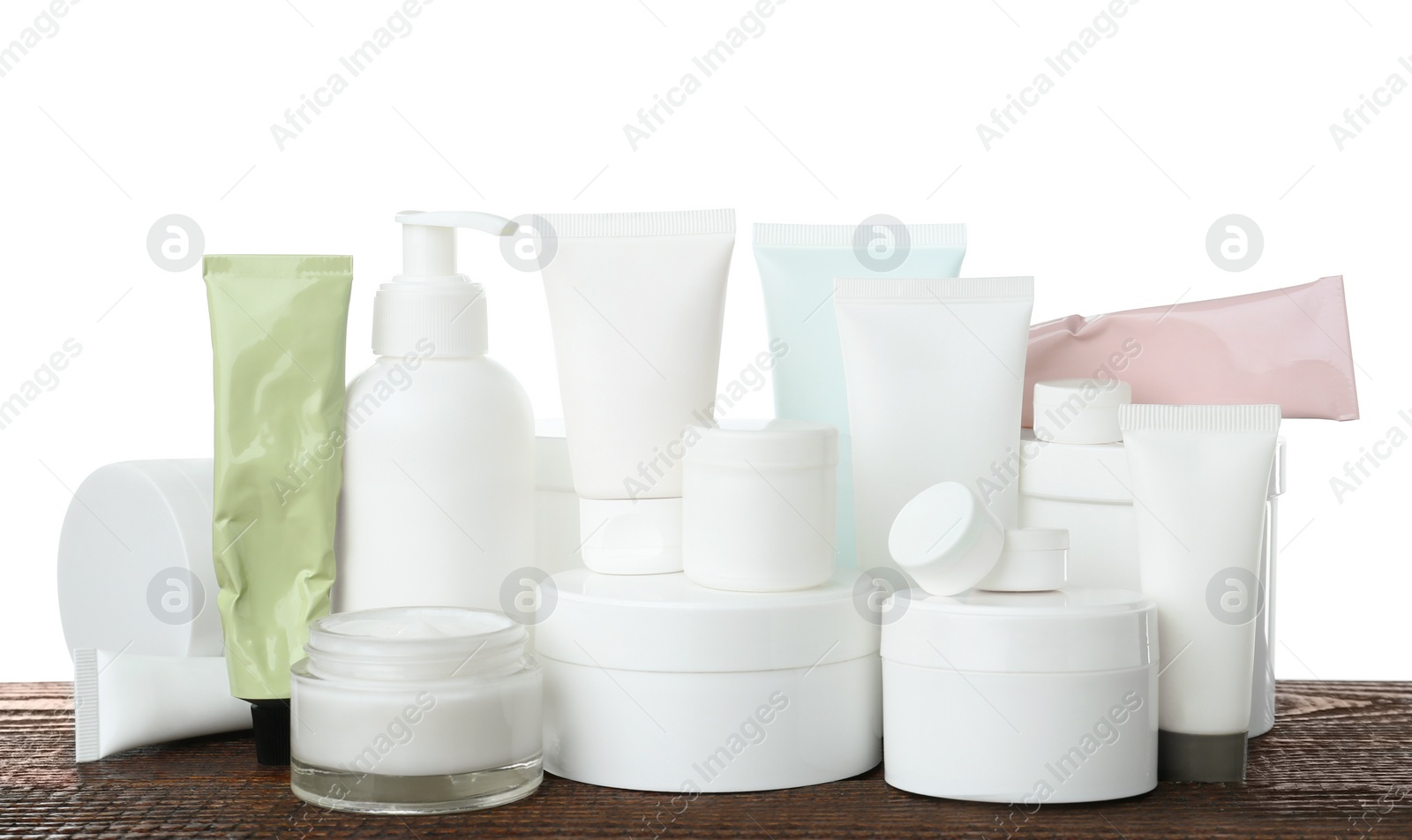 Photo of Set of different cosmetic products on wooden table against white background