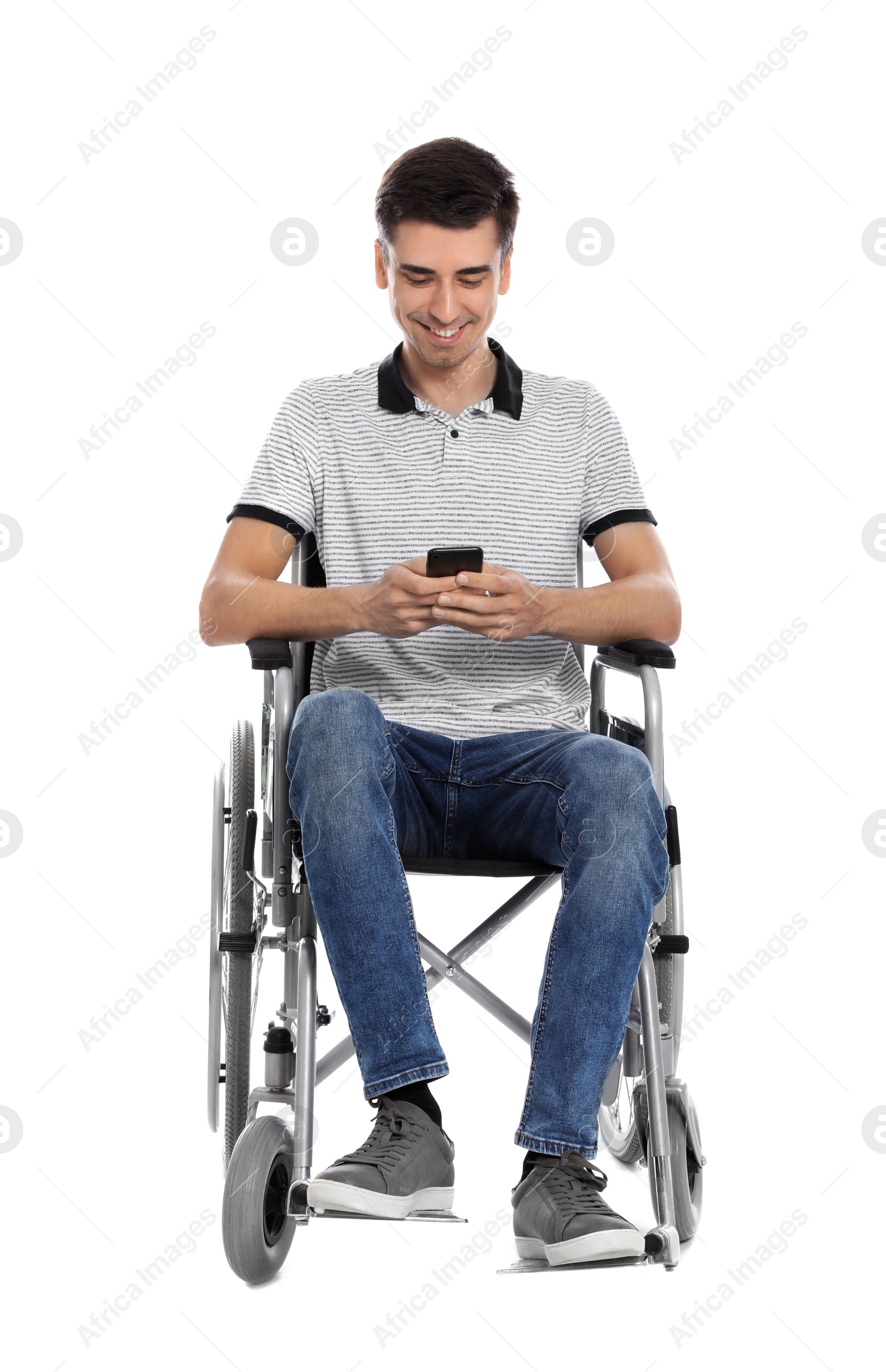 Photo of Young man in wheelchair using mobile phone isolated on white