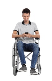Young man in wheelchair using mobile phone isolated on white