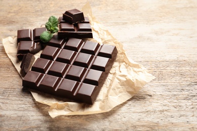 Tasty chocolate on wooden background. Space for text