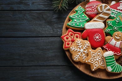 Photo of Tasty homemade Christmas cookies on dark blue wooden table, top view. Space for text