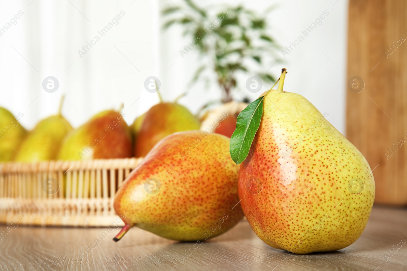 Photo of Ripe juicy pears on brown wooden table indoors, closeup