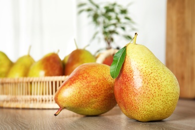 Photo of Ripe juicy pears on brown wooden table indoors, closeup