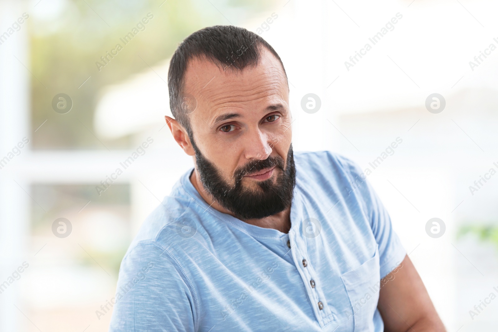 Photo of Portrait of handsome mature man on blurred background