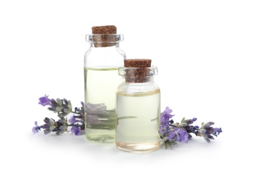 Photo of Bottles with natural lavender oil and flowers on white background