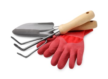 Photo of Gardening gloves, trowel and rake isolated on white