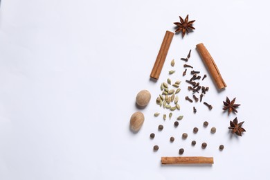 Photo of Christmas tree made of different spices on white table, flat lay. Space for text