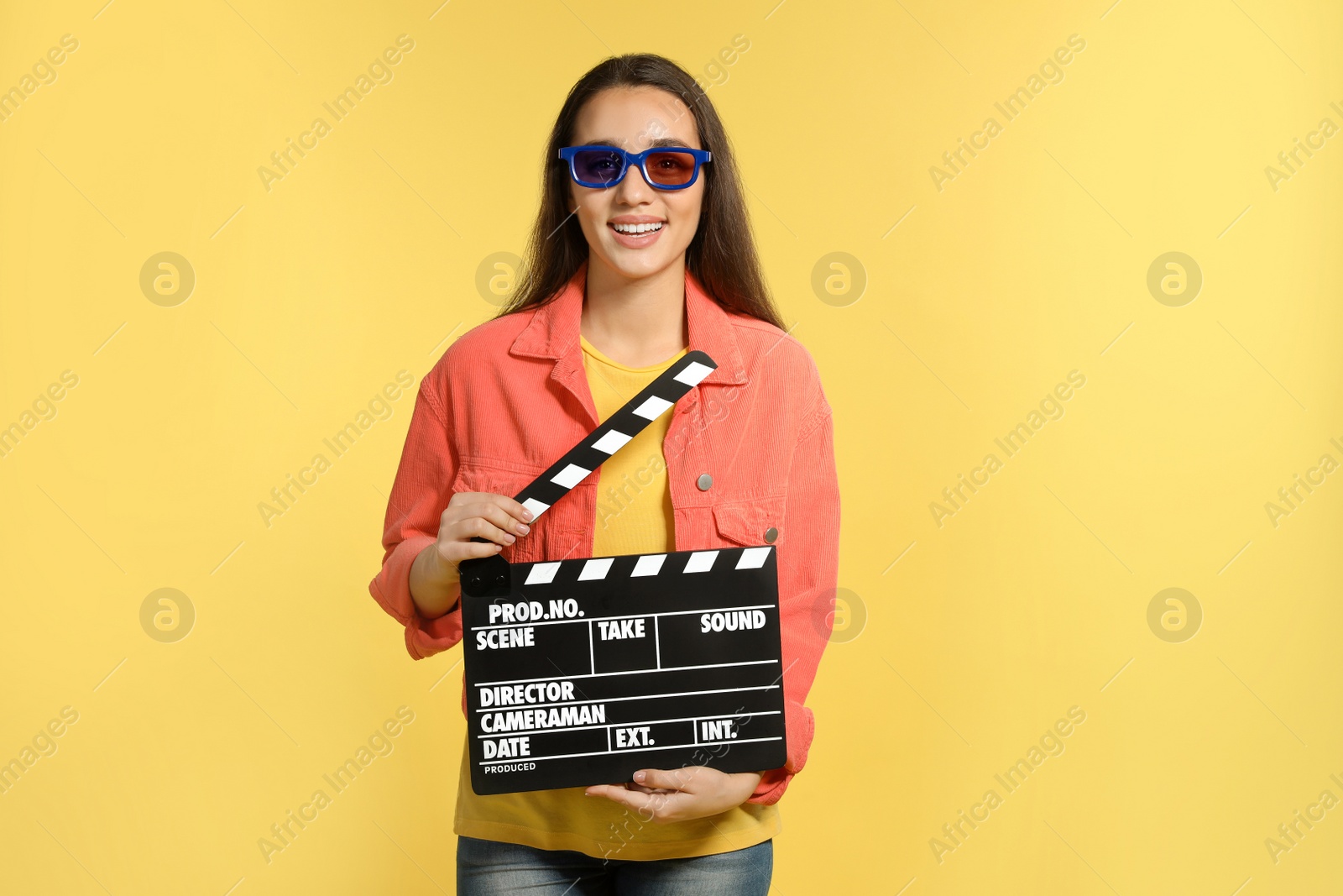 Photo of Woman with 3D glasses and clapperboard on color background. Cinema show