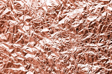 Image of Crumpled rose gold foil as background, closeup view
