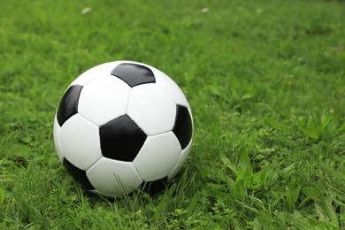 Photo of Soccer ball on green grass outdoors, space for text
