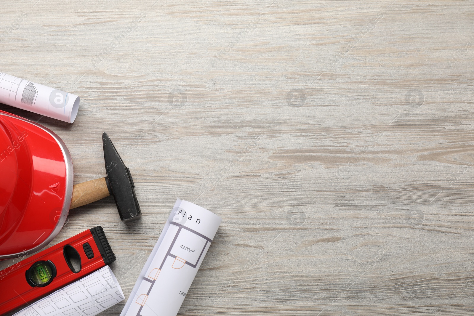 Photo of Flat lay composition with building level and other construction tools on white wooden table, space for text