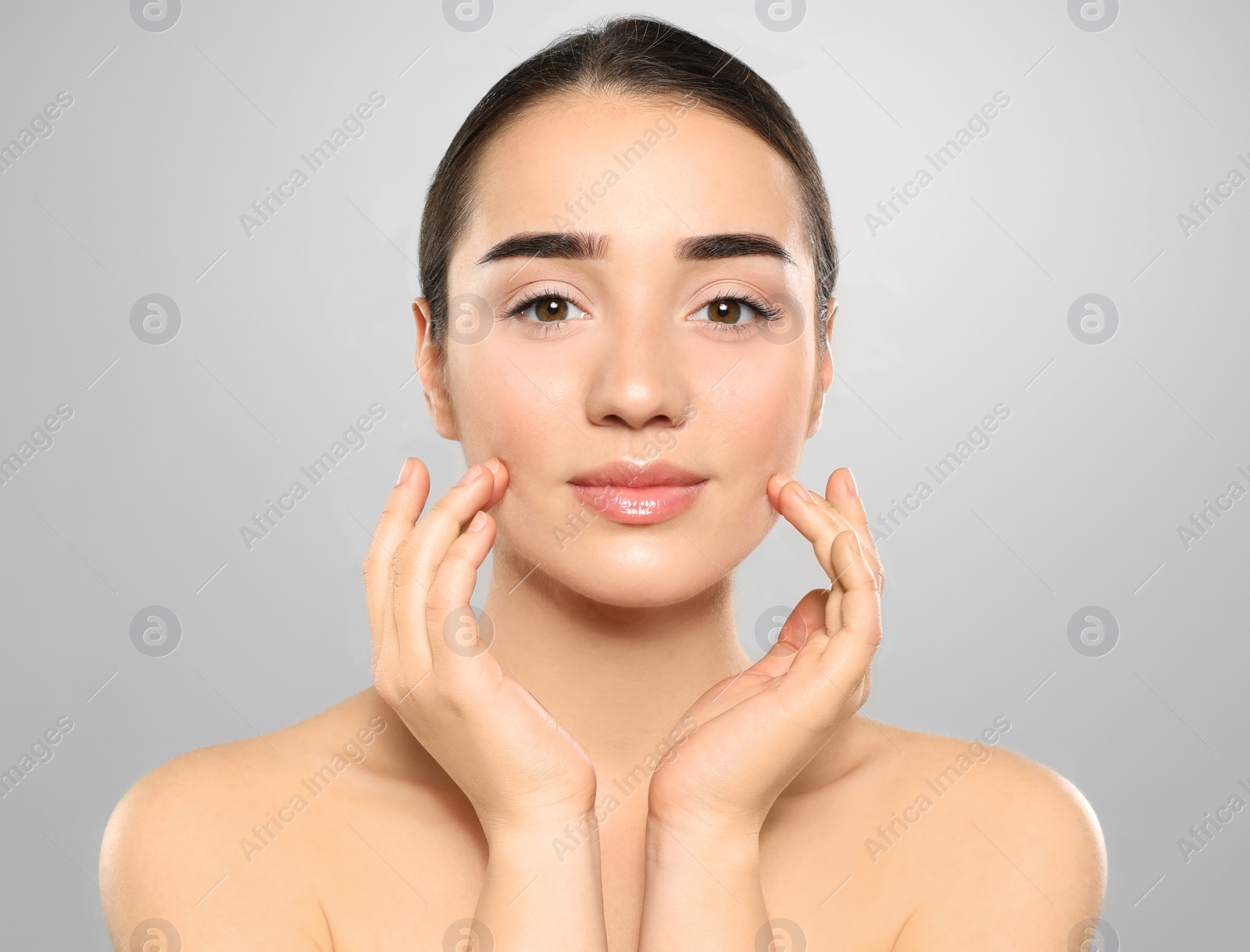 Photo of Portrait of young woman with beautiful face against color background