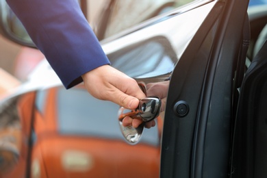 Closeup view of man opening car door