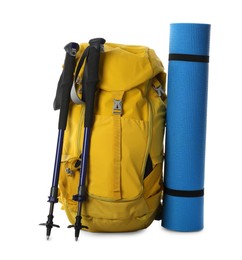 Photo of Trekking poles, backpack and camping mat on white background