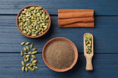 Flat lay composition with different spices on blue wooden table