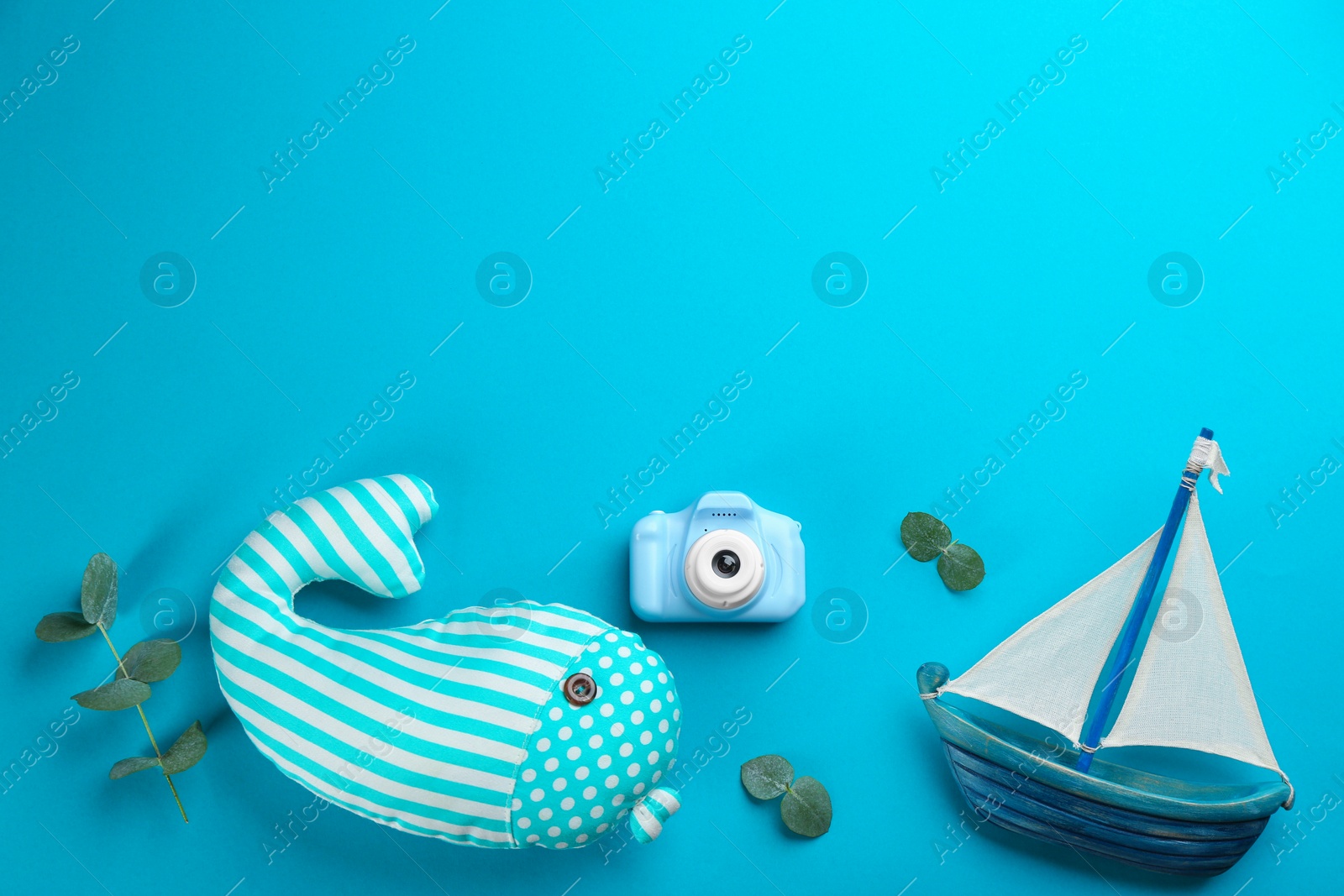 Photo of Flat lay composition with little photographer's toy camera on blue background. Space for text