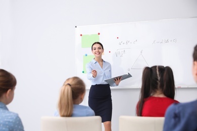 Young teacher and students in modern classroom