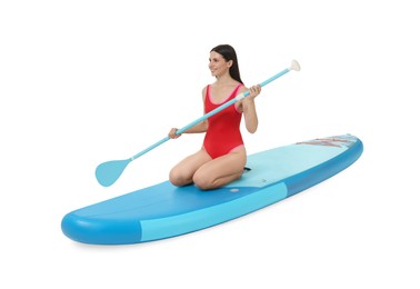 Photo of Happy woman with paddle on blue SUP board against white background