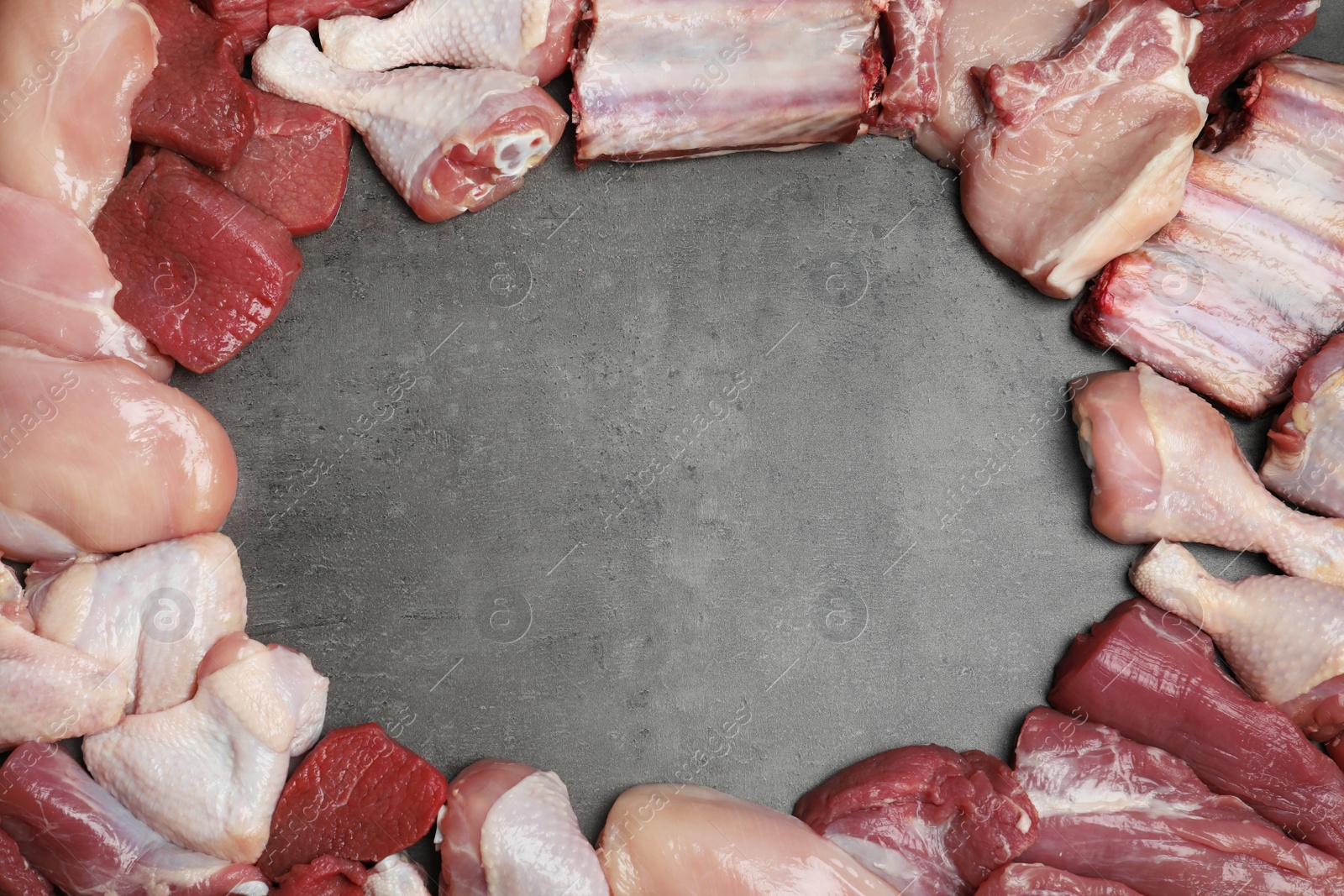 Photo of Flat lay composition with fresh raw meat and space for text on gray background