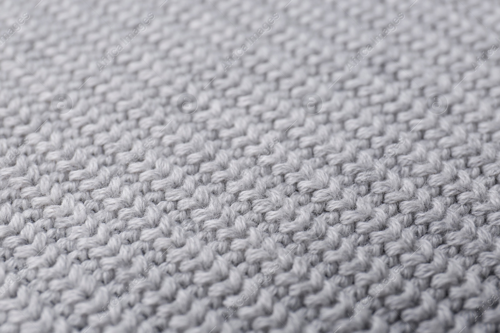 Photo of Grey knitted fabric as background, closeup view