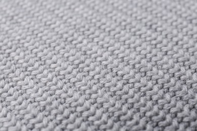 Grey knitted fabric as background, closeup view