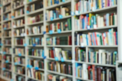 Photo of Blurred view of shelves with books in library