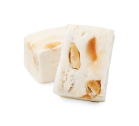 Photo of Pieces of delicious nougat on white background