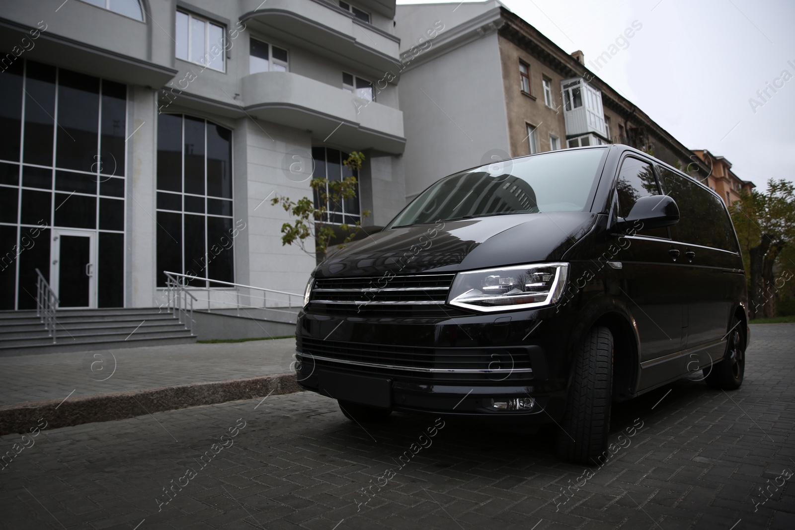 Photo of Black delivery van parked on street near building